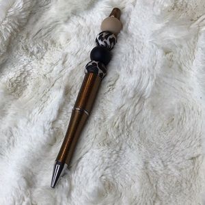 Handcrafted beaded. tan/black/animal print. Made with bpa free silicone.